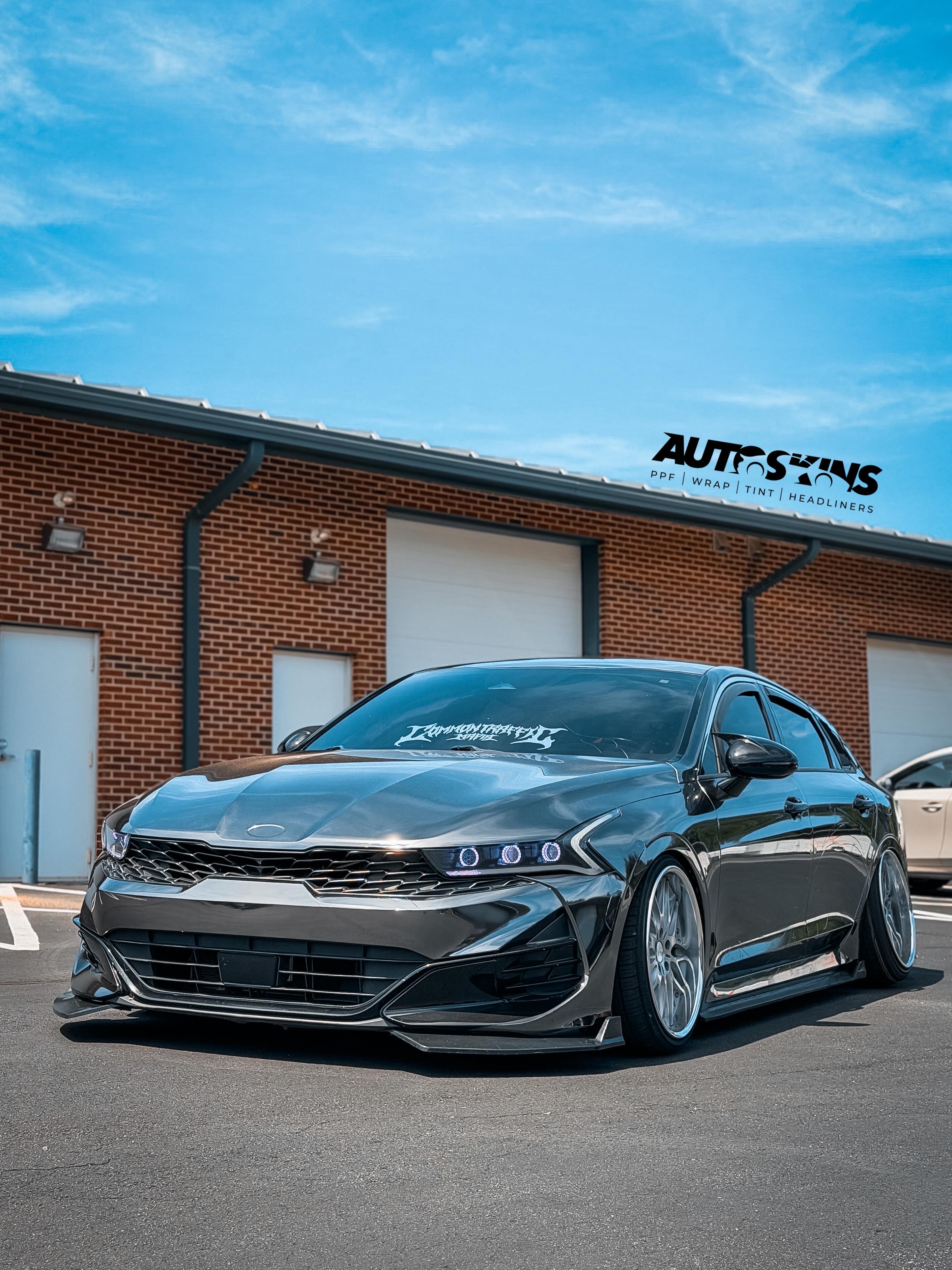 Wrapped vehicle front quarter outside the shop