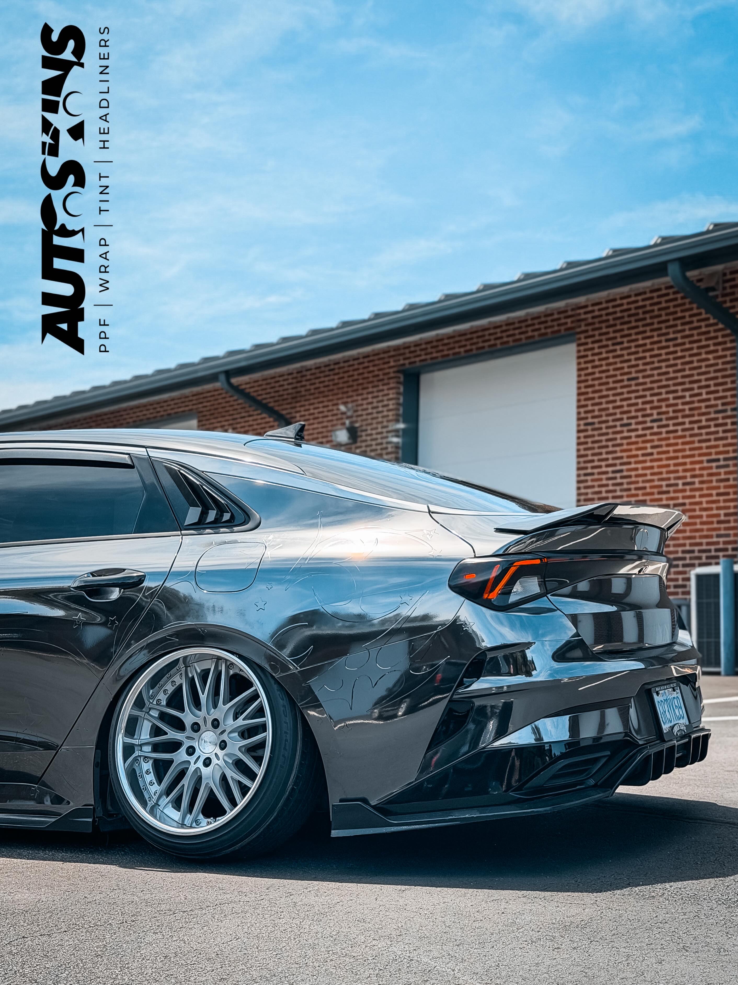 Wrapped vehicle rear angle with custom wheels