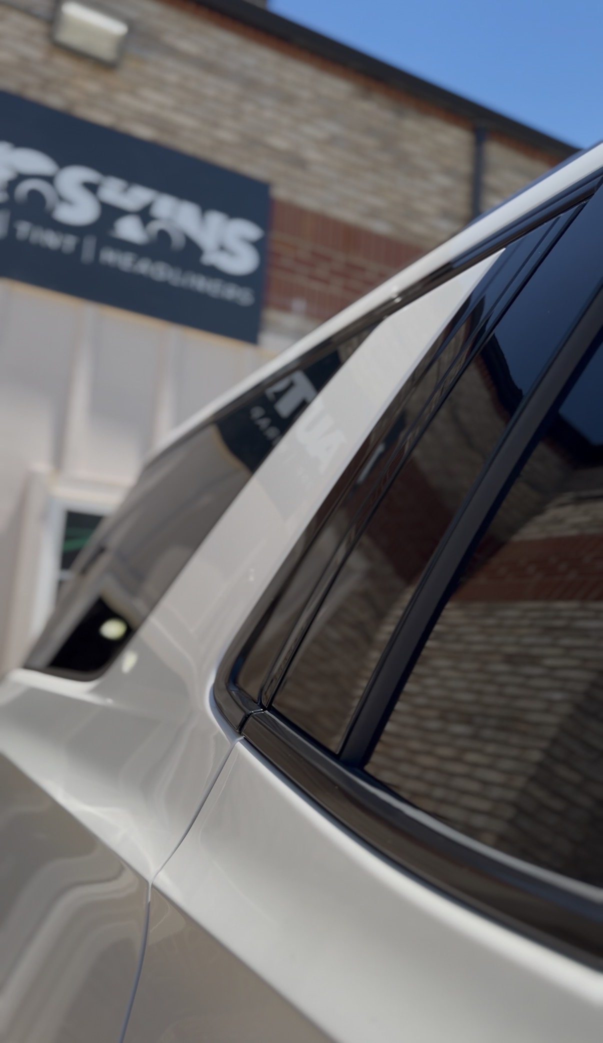 Chrome delete trim detail on a white vehicle window