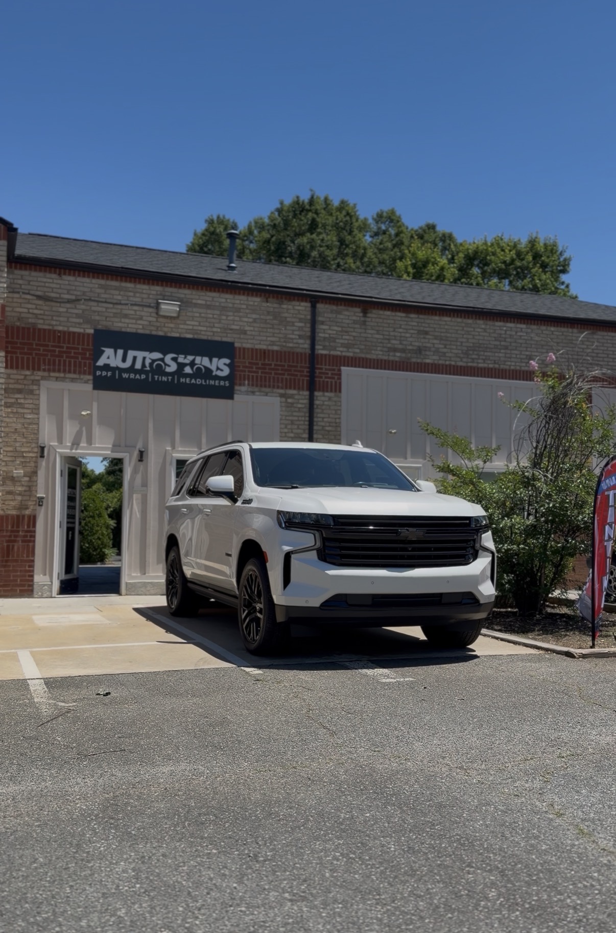 White vehicle after chrome delete service outside Autoskins